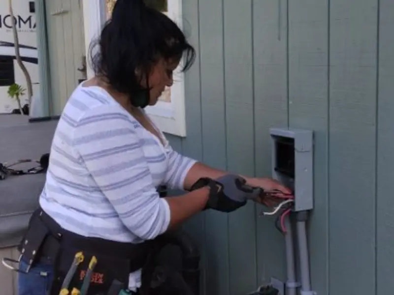 Licensed electrician wiring an exterior subpanel in Tybee Island
